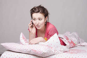 Image showing Young girl talking on the phone in bed