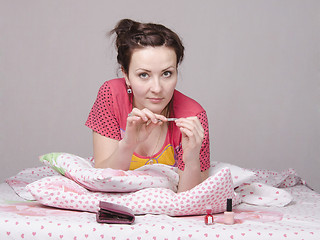 Image showing girl has manicure lying in bed