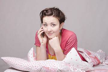 Image showing Girl talking on the phone in bed