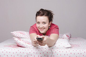 Image showing young girl is watching TV in bed