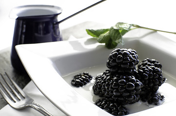 Image showing Bowl of fresh blackberries and milk.