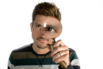 Image showing Man looking through magnifying glass