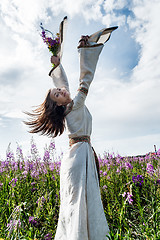 Image showing Beautiful woman relaxing with flowers