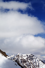 Image showing Winter snowy mountains and sky with clouds at sun day