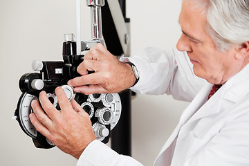 Image showing Optometrist Setting Phoropter For Eye Test