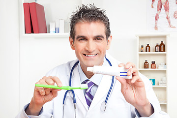 Image showing Doctor Holding  Tooth Brush and Toothpaste