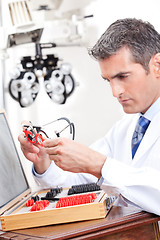 Image showing Optometrist Holding Measuring Eye Glasses