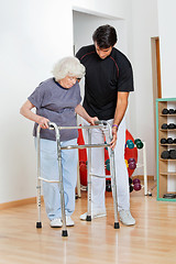 Image showing Trainer Assisting Senior Woman In Moving