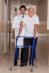 Image showing Doctor helping Patient use Walker