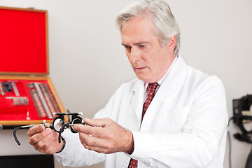 Image showing Optometrist Examining Trial Frame For Eye Test