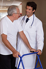 Image showing Doctor helping Patient use Walker