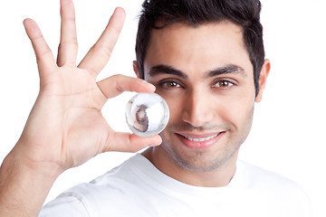 Image showing Young Man Holding Crystal Ball