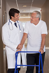 Image showing Doctor helping Patient use Walker