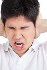 Image showing Young Asian Man Covering Ears