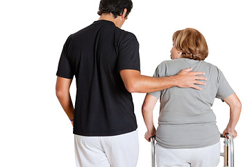 Image showing Trainer Assisting Senior Woman With Her Walker