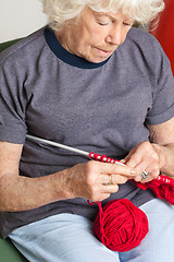 Image showing Senior Woman Knitting With Red Wool