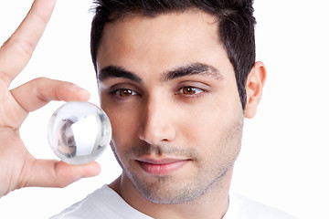 Image showing Young Man Holding Crystal Ball