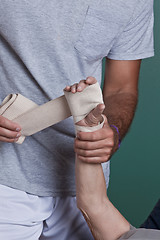 Image showing Therapist applying Bandage on the Hand