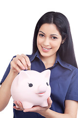 Image showing Smiling Woman Holding Piggy Bank