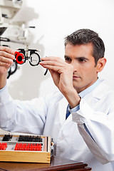 Image showing Eye Doctor Checking Lens Of Trial Frames