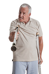 Image showing Man Holding Crutch Like a Weapon