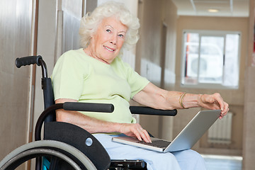 Image showing Senior Woman In Wheelchair Using Laptop