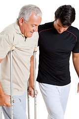 Image showing Trainer Helping Senior Man With Crutches