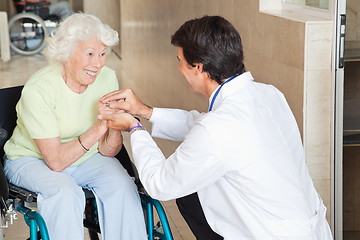 Image showing Doctor Comforting Happy Senior Woman