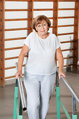 Image showing Woman Walking With The Help Of Support Bars