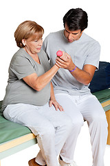 Image showing Therapist Giving Muscle Training Over White Background