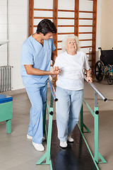 Image showing Therapist Assisting Tired Senior Woman On Walking Track