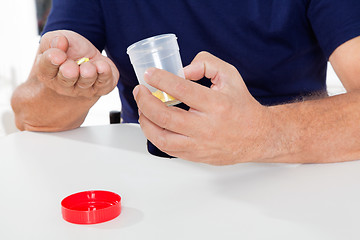 Image showing Senior Man Holding Pills And Bottle