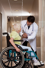 Image showing Doctor with Patient on Wheel Chair