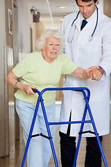 Image showing Doctor Showing Way To The Patient Using Walker