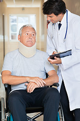 Image showing Doctor Communicating With Patient On Wheel Chair