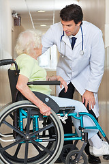 Image showing Doctor Communicating With Senior Woman Sitting In Wheelchair