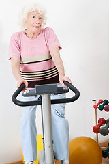 Image showing Happy Senior Woman Exercising On Bike