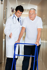 Image showing Doctor Assisting Senior Man On a Walker