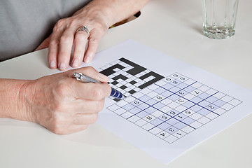 Image showing Mature Woman playing Sudoku Puzzle