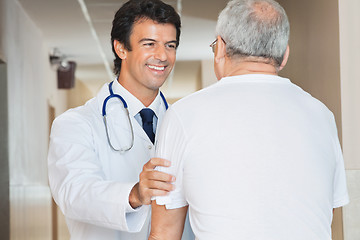 Image showing Doctor Assisting Senior Man