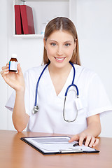 Image showing Doctor Holding Medicine Bottle