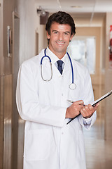 Image showing Male Doctor Standing with Folder