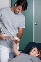 Image showing Therapist applying Bandage on the Hand