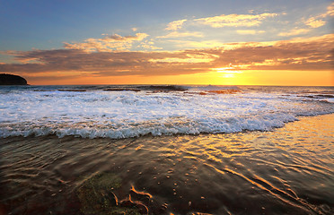 Image showing Waves crash onto the rock shelf at high tide