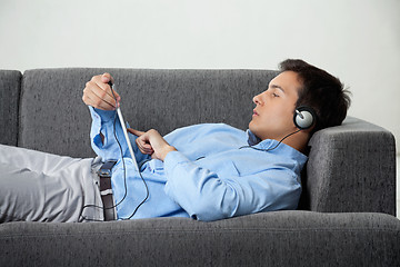 Image showing Relaxed Man Listening Music On Digital Tablet