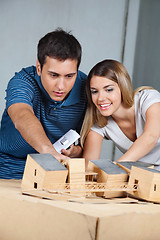 Image showing Couple Working On Model House