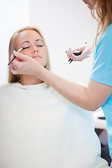 Image showing Woman Applying Eyeshadow with Brush