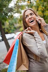 Image showing Woman On A Call While Carrying Shopping Bags