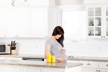 Image showing Pregnant Woman Looking at Belly