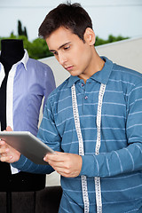 Image showing Male Tailor Holding Tablet PC